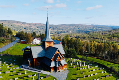 Stave Church, a traditional wooden Norwegian church, surrounded by lush greenery, highlighting it as a top attraction in Norway.