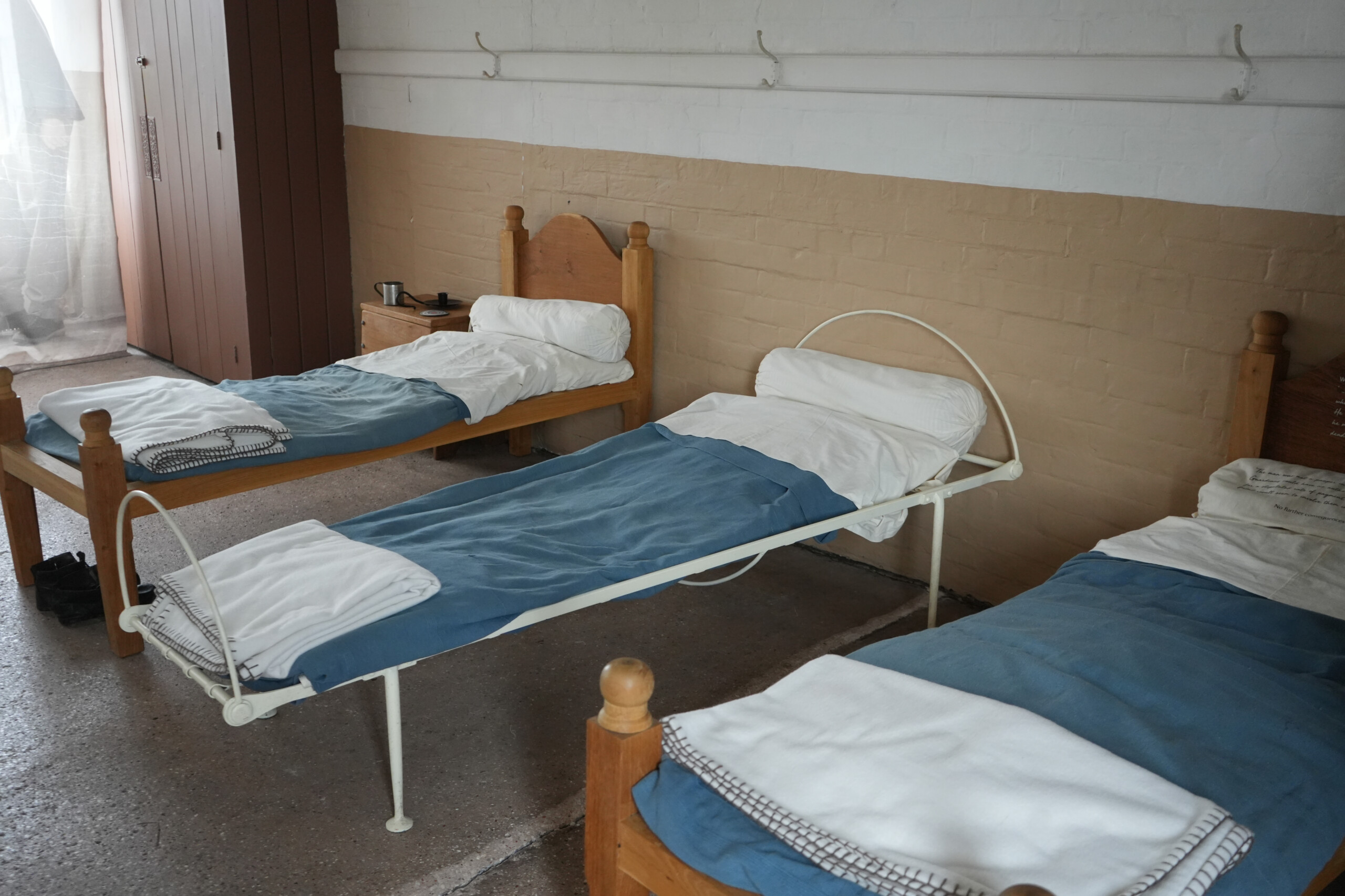 Close Up Of Workhouse Ward Beds With Blue Covers And Iron Frames Southwell Workhouse Nottinghamshire England Close up of the ward beds