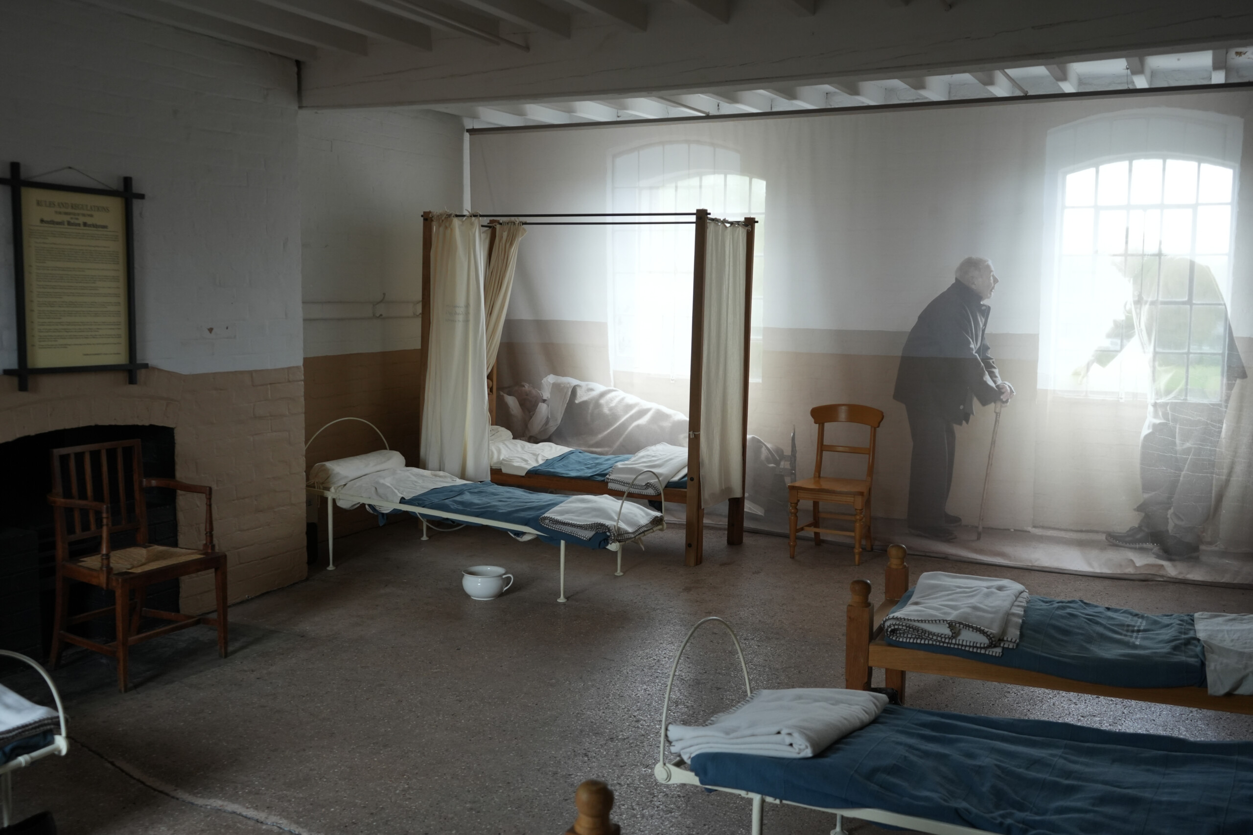 Historical Ward Room With Beds And Privacy Curtain Display Southwell Workhouse Nottinghamshire England Ward room at the Workhouse in Southwell