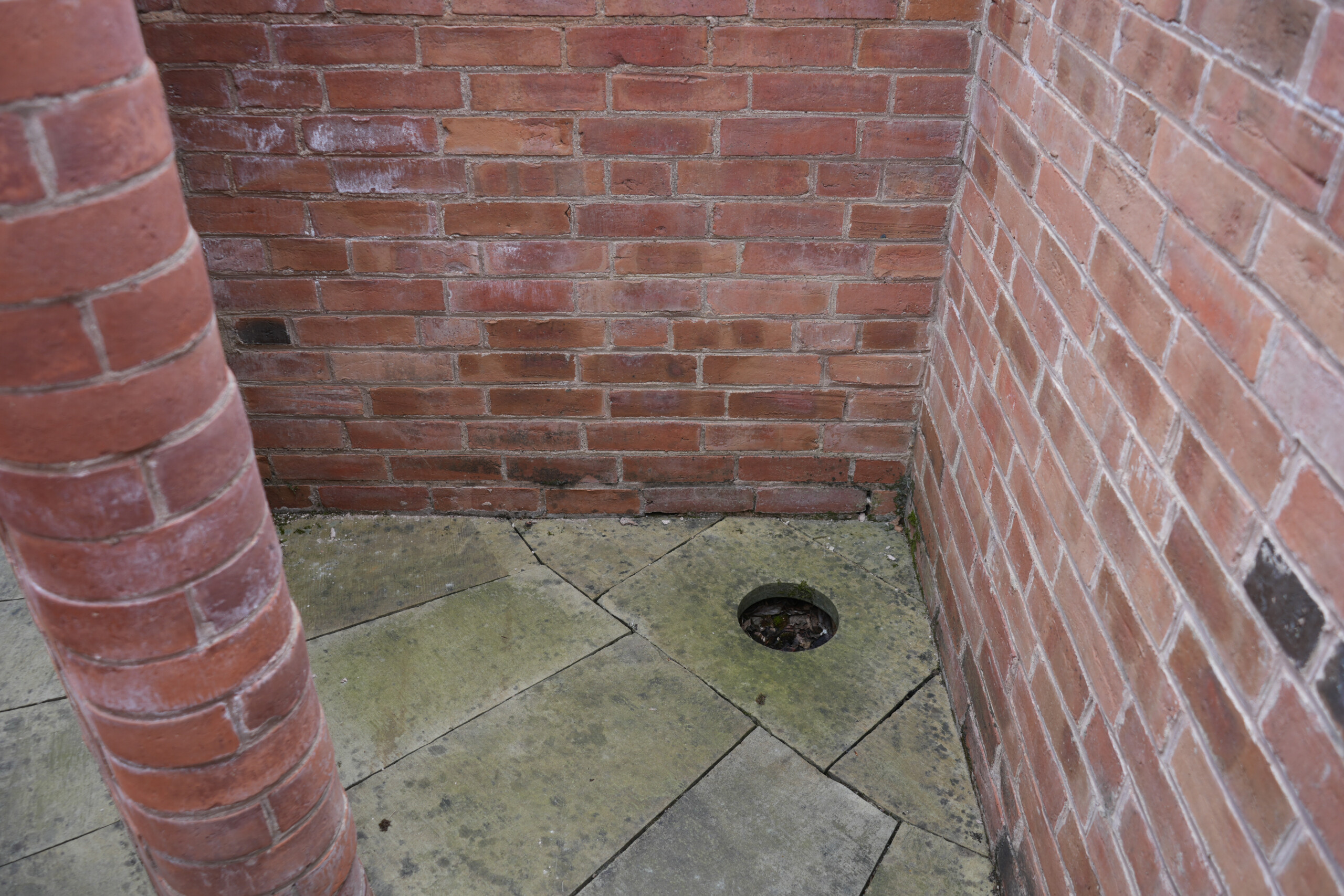 Outdoor Toilet Drain in Enclosed Brick Yard at Southwell Workhouse Nottinghamshire England Close up of the privy