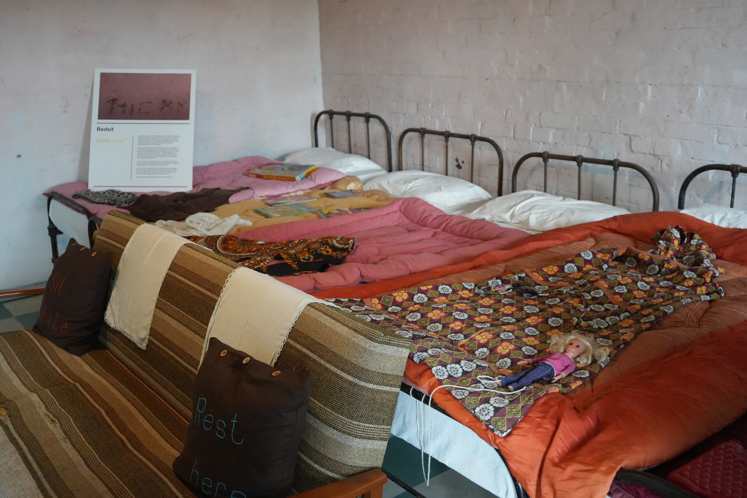 Shared Bedsit with Colourful Bedding and Toys from 1970s Southwell Nottinghamshire England Bedsit at the Workhouse in Southwell